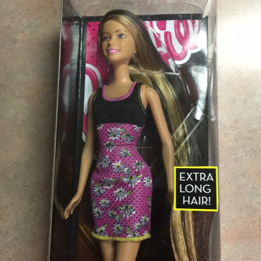Barbie her name is answer. She has extra long hair